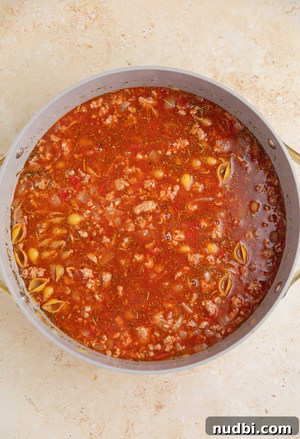 One-Pot Ground Turkey Pasta Dinner Recipe 7 Pasta shells added to turkey, broth and tomato mixture in pan.