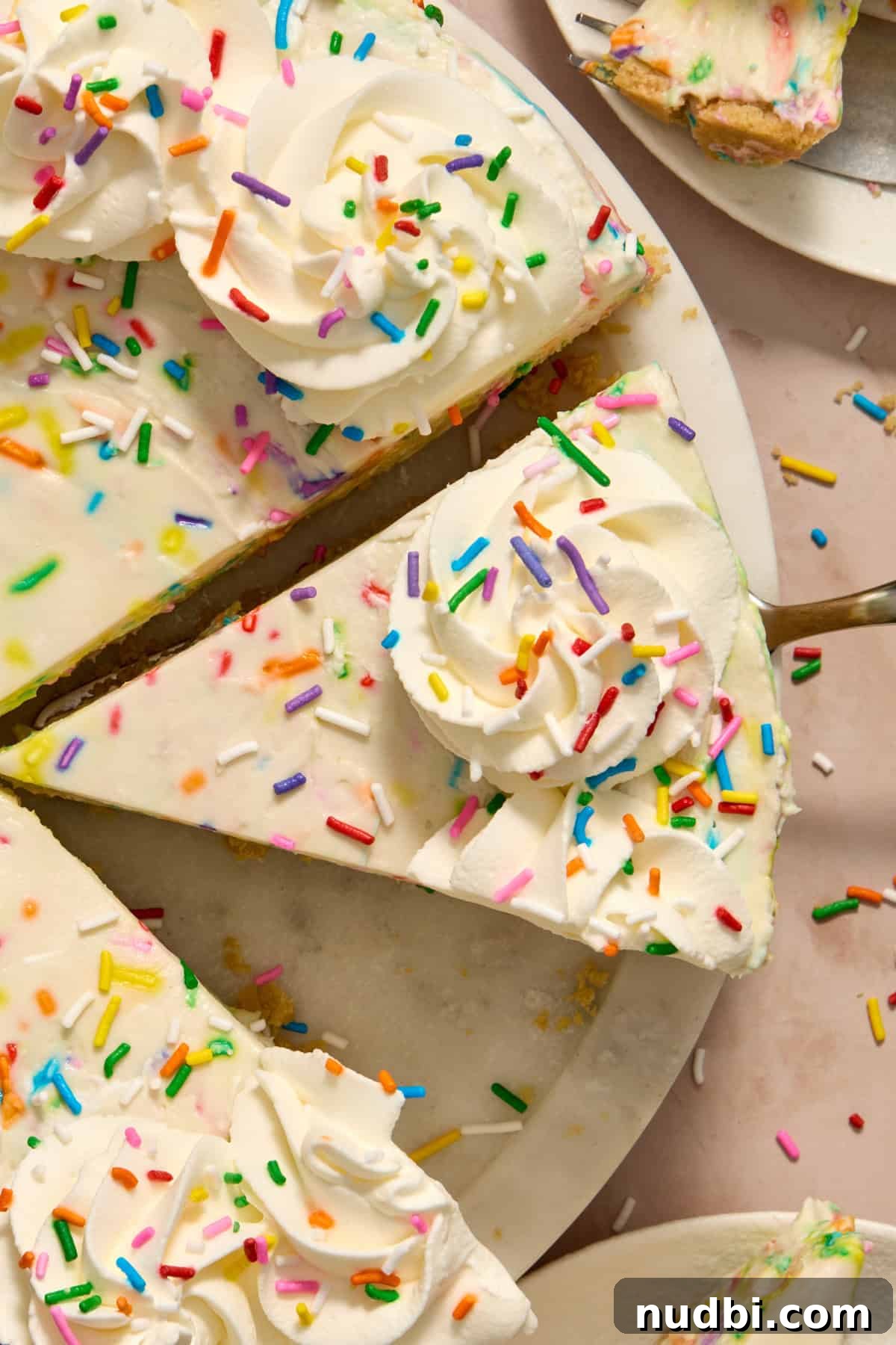 No-Bake Funfetti Cheesecake Recipe for Celebrations 2 Overhead view of slices of funfetti cheesecake.