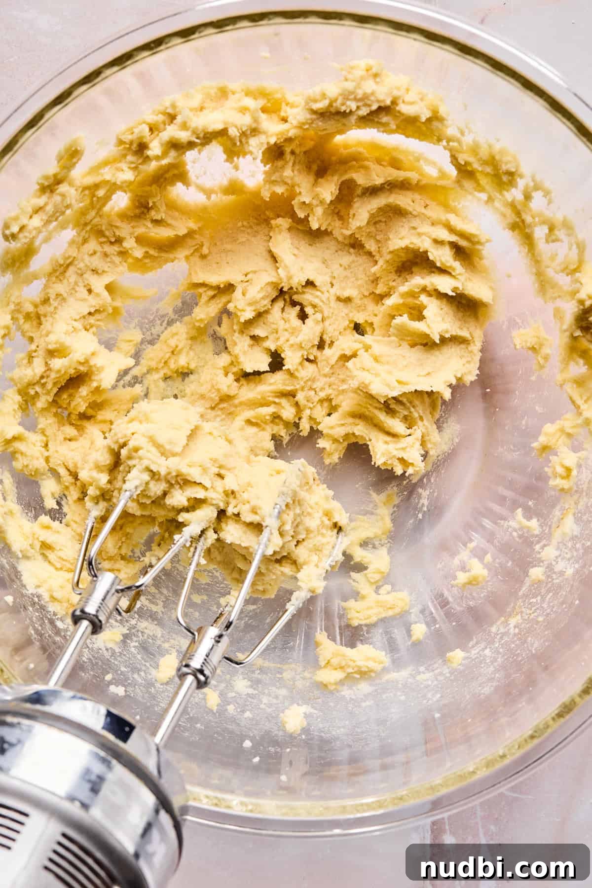 Iced Sugar Cookie Recipe: Soft, Chewy Cookies with Royal Icing 7 Egg, vanilla and almond extract mixed into butter and sugar in mixing bowl.
