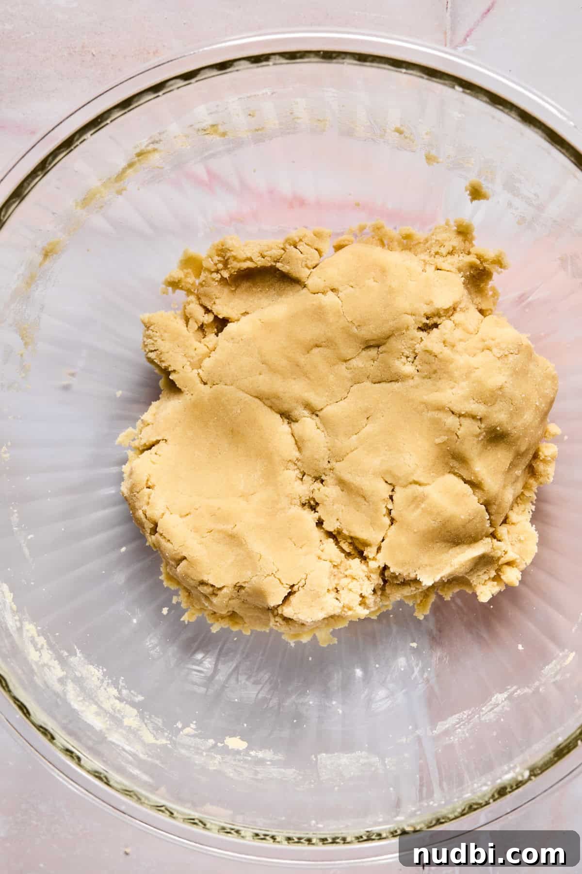 Iced Sugar Cookie Recipe: Soft, Chewy Cookies with Royal Icing 9 Sugar cookie dough in glass mixing bowl.