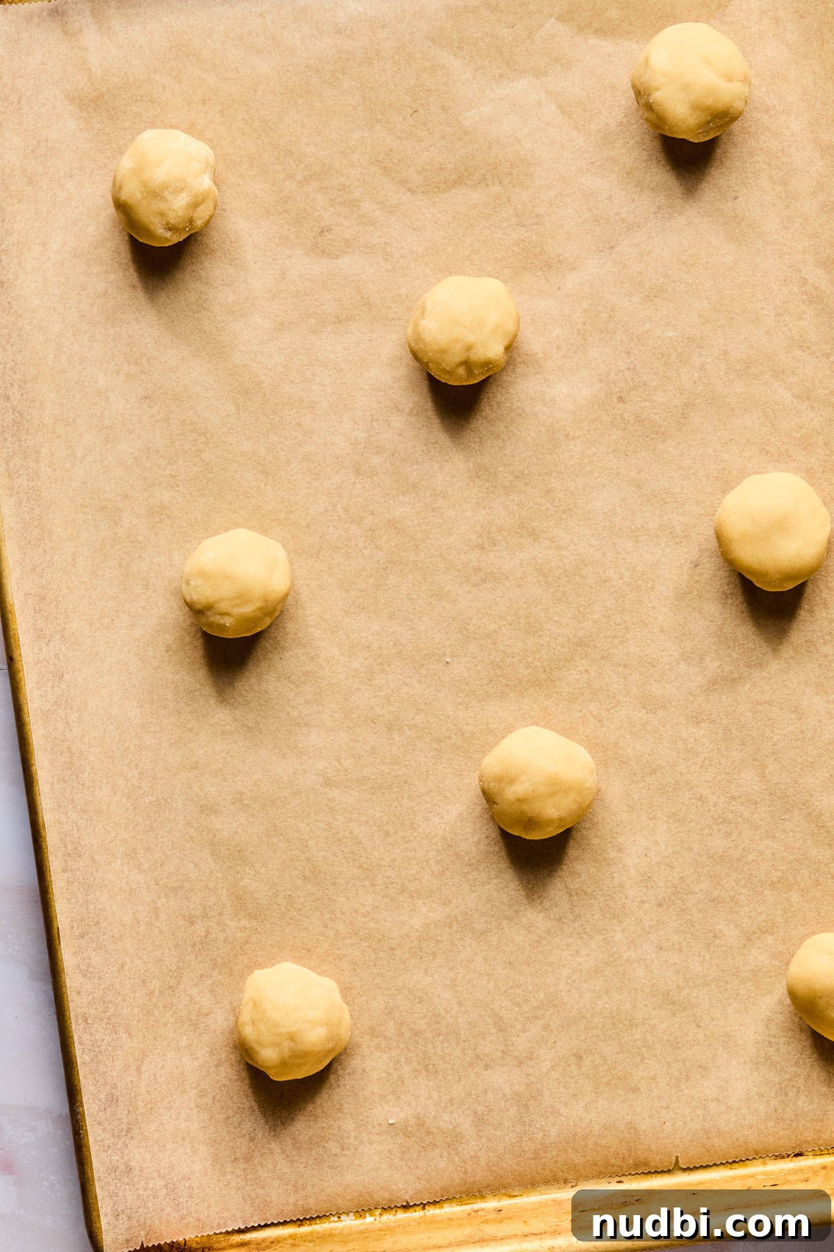Iced Sugar Cookie Recipe: Soft, Chewy Cookies with Royal Icing 10 Sugar cookie dough on parchment lined cookie sheet.