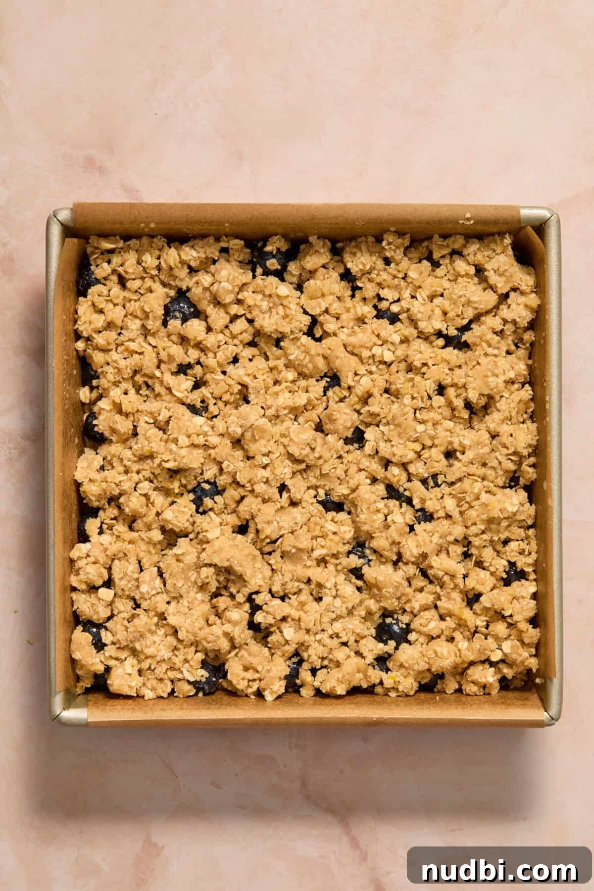 Lemon oat crumble sprinkled over berries.