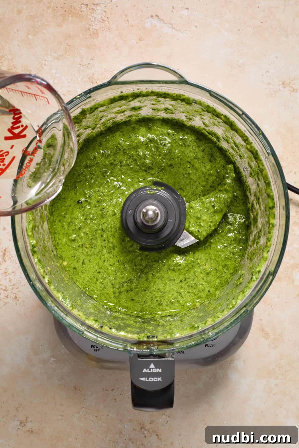 Creamy Tortellini Pesto Salad with Cherry Tomatoes & Spinach 6 Olive oil being poured into pesto mixture in food processor.