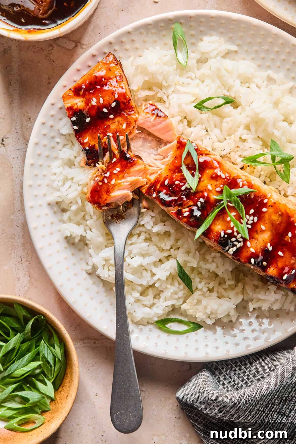 Crispy Grilled Teriyaki Salmon with Sticky Glaze Recipe 11 Plate with rice and grilled salmon with fork showing the flaked fish.