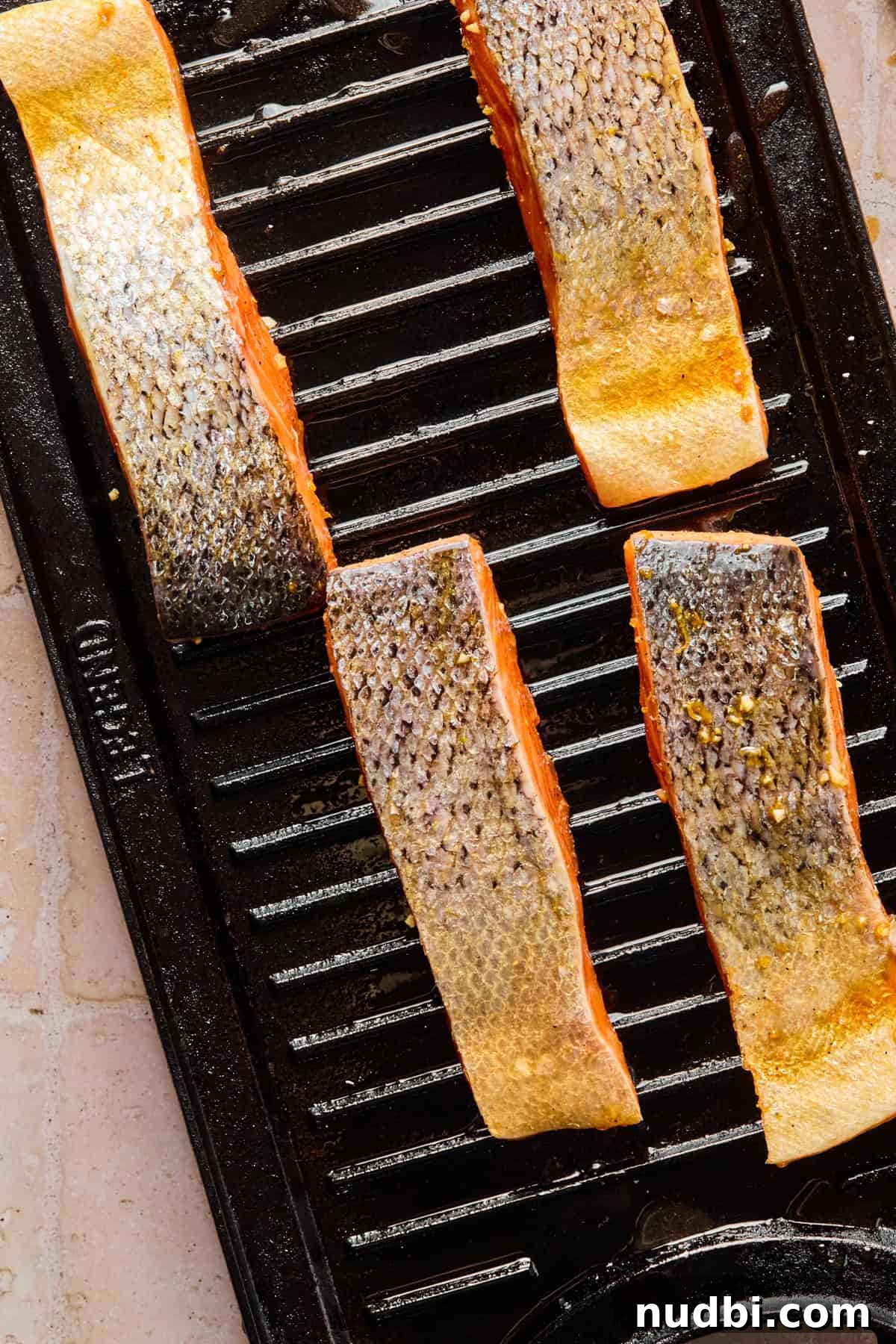 Crispy Grilled Teriyaki Salmon with Sticky Glaze Recipe 8 Salmon filets on grill.