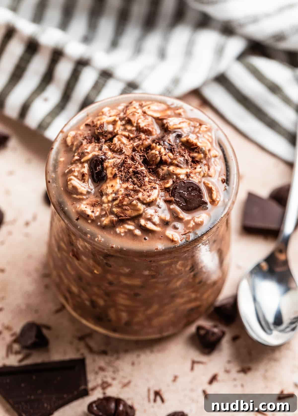Triple Chocolate Overnight Oats Recipe for Chocolate Lovers 2 Chocolate overnight oats in glass jar topped with chocolate chips and chocolate shavings.