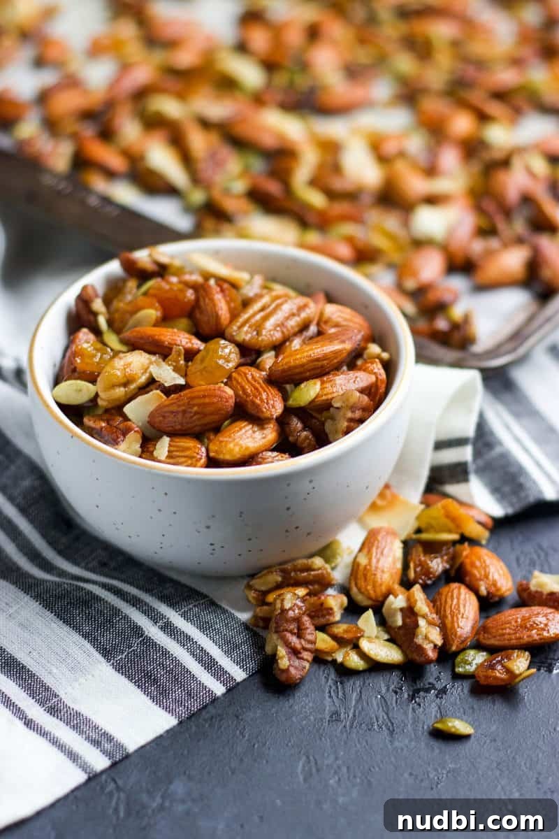 Maple Roasted Trail Mix Recipe with Nuts & Seeds 2 Bowl of easy maple trail mix in front of sheet pan with mix on it.