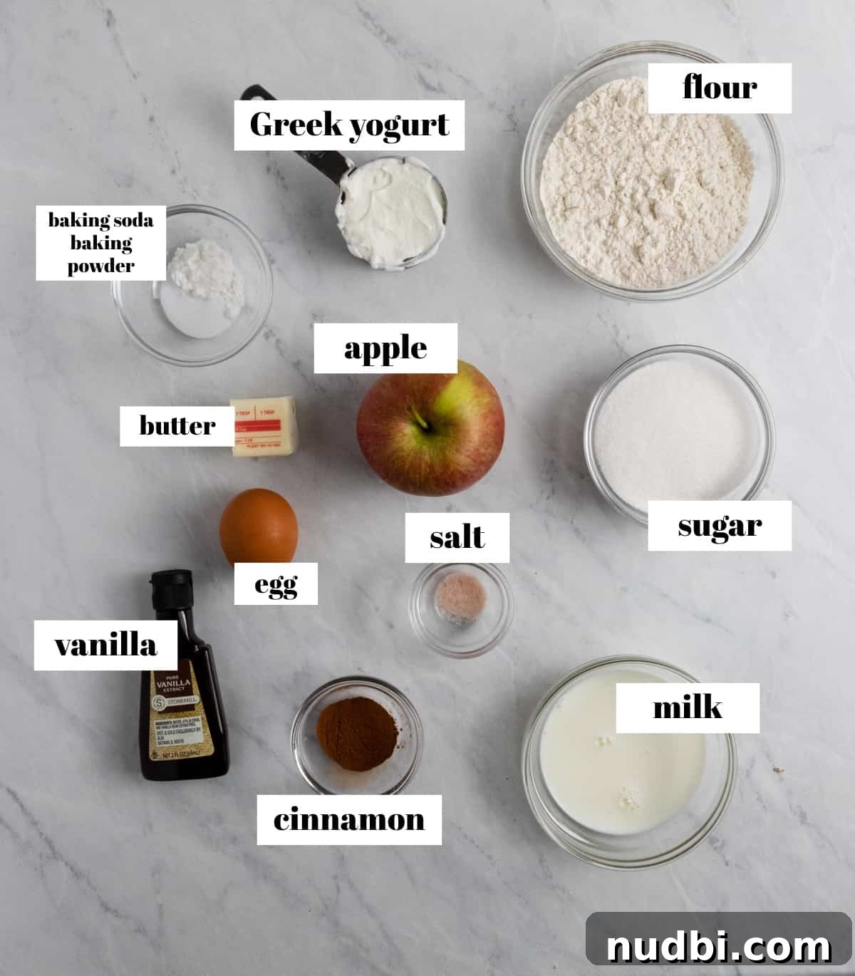 Apple Cider-Glazed Apple Cinnamon Donuts Recipe 3 Flour, apple, sugar, cinnamon and other ingredients labeled on counter.