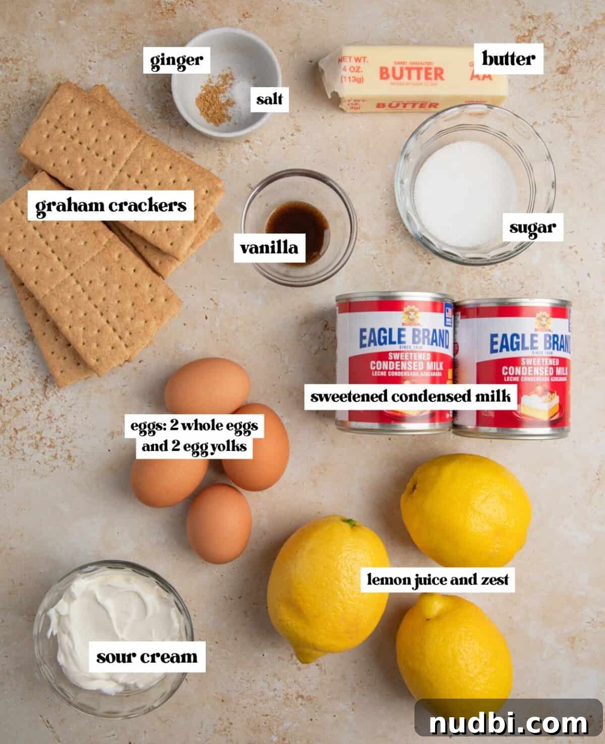 Creamy Lemon Bars with Graham Cracker Crust Recipe 4 Lemons, graham crackers, eggs and other ingredients labeled on surface.