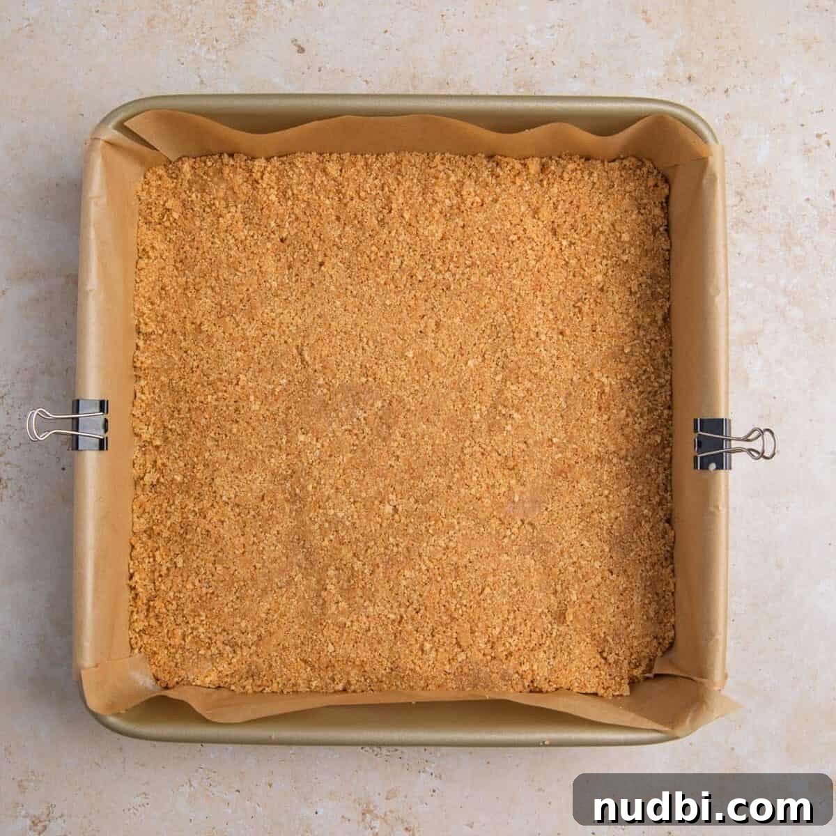 Creamy Lemon Bars with Graham Cracker Crust Recipe 7 Graham cracker crust pressed into parchment lined pan.