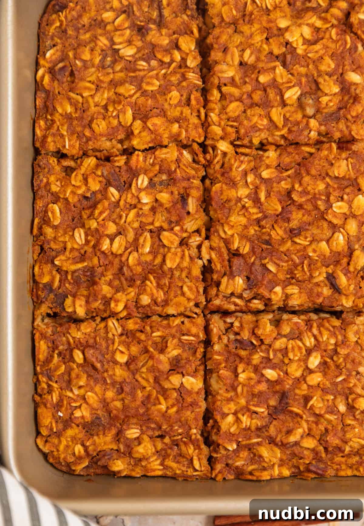 Sliced pumpkin oatmeal bake recipe in pan.