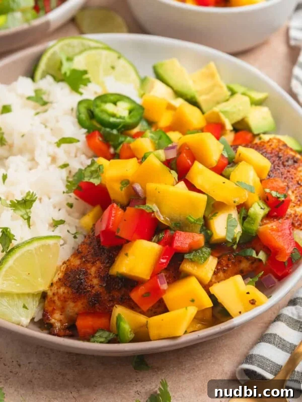 Sticky Honey Mustard Chicken Drumsticks Recipe 13 Mango salsa chicken served on plate with white rice and lime.