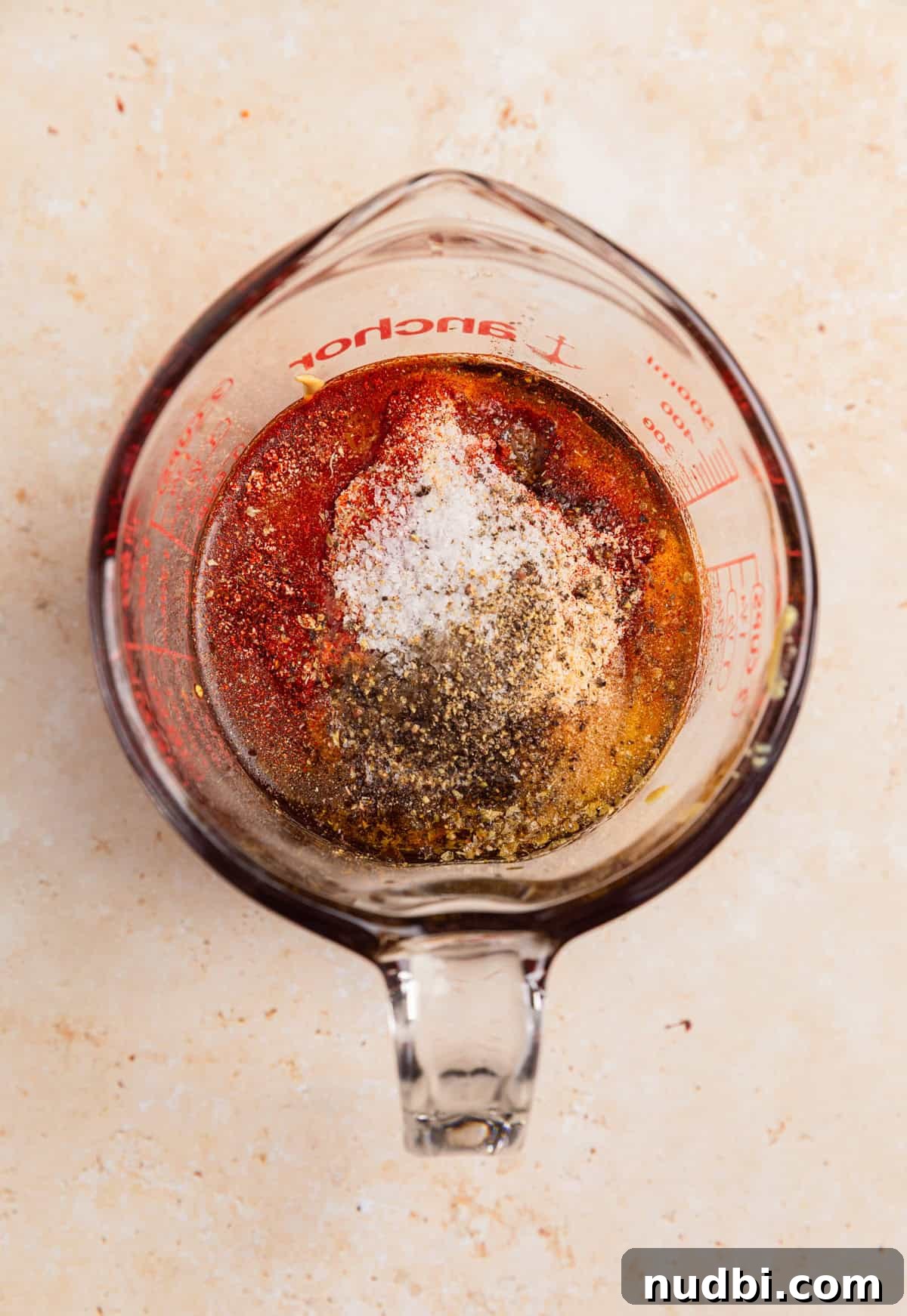 Sticky Honey Mustard Chicken Drumsticks Recipe 5 Ingredients in measuring cup to make honey mustard marinade.