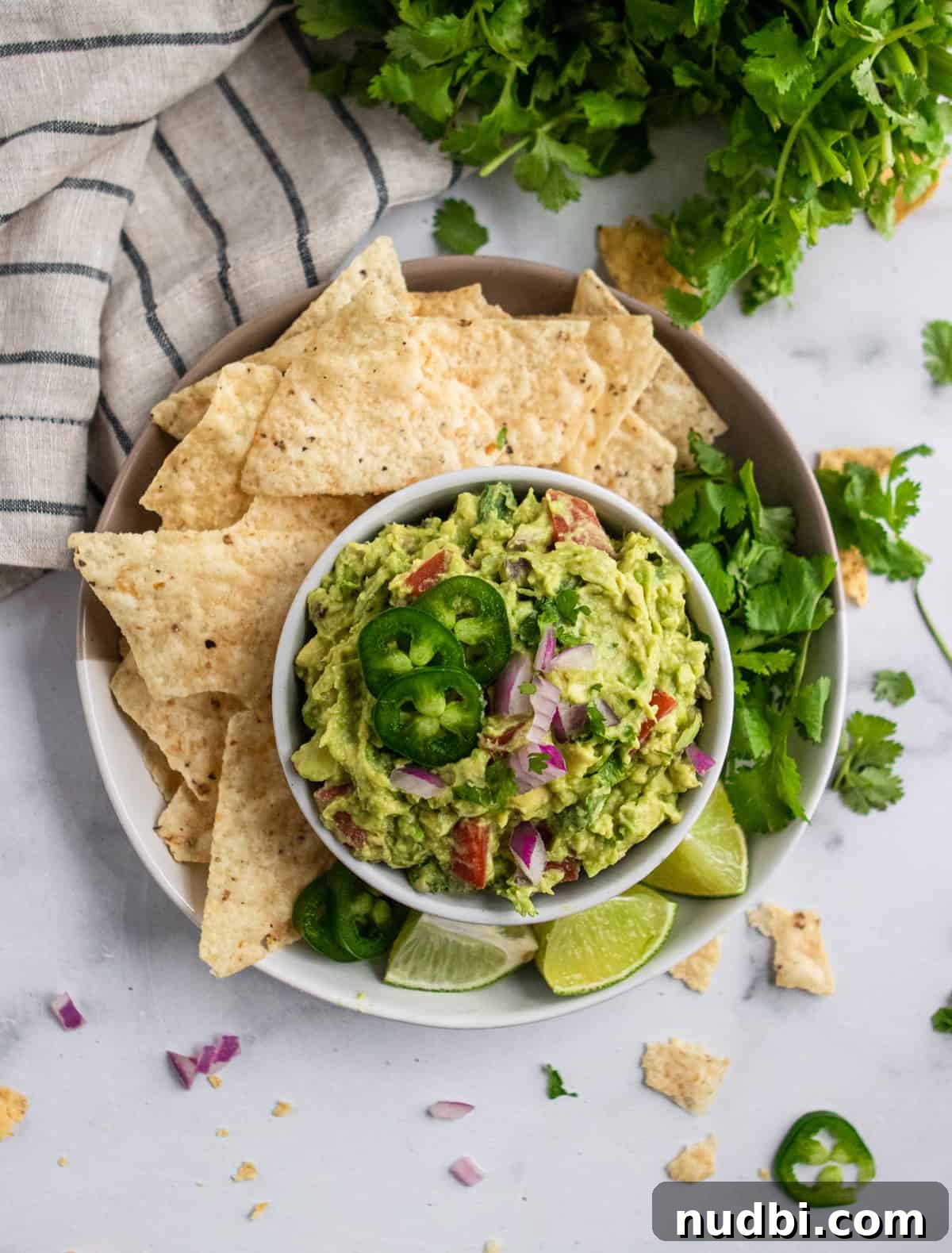 Creamy Avocado Guacamole Recipe with Zesty Lime and Cilantro 5 Guacamole with chips and fixins.