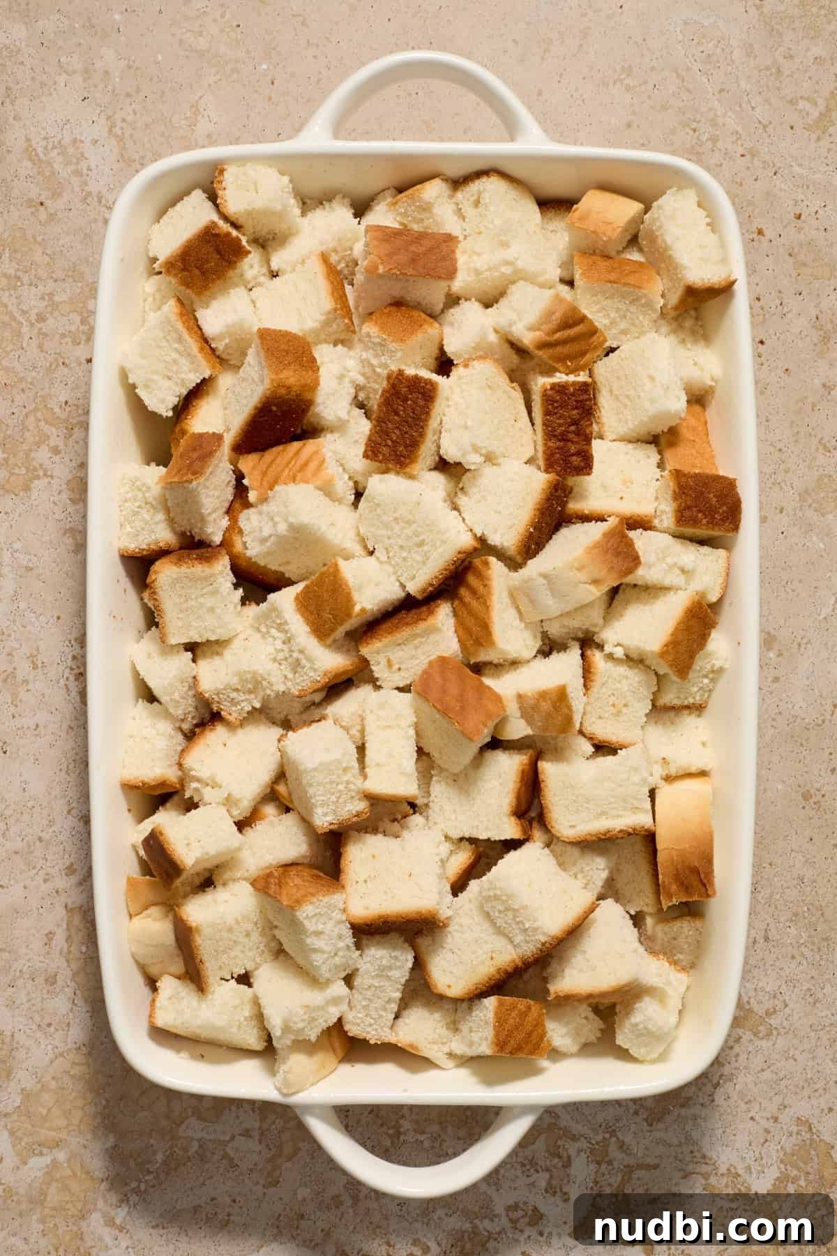 Overnight French Toast Casserole with Maple Cinnamon Glaze 5 Bread cubes in casserole dish.