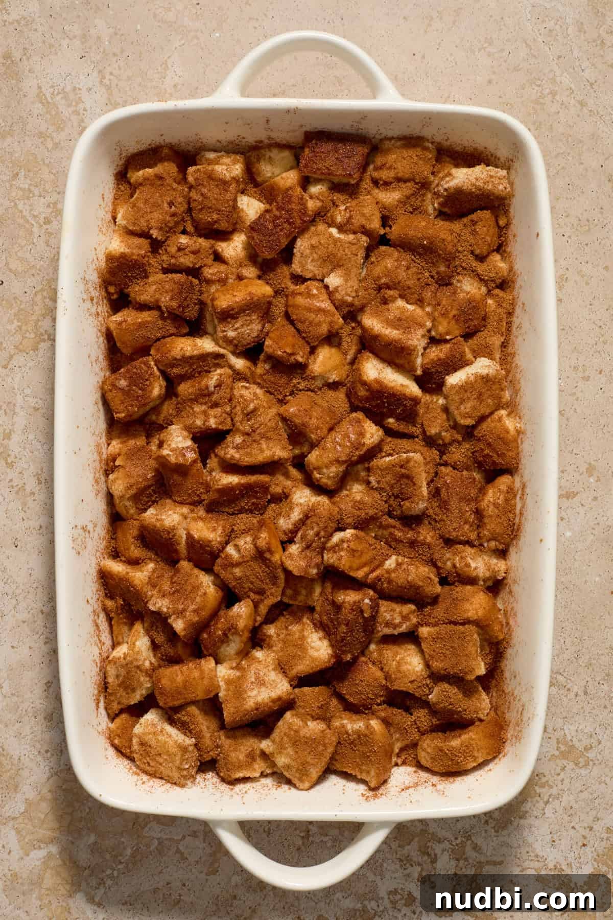 Overnight French Toast Casserole with Maple Cinnamon Glaze 9 French toast casserole with texas toast tossed with cinnamon and brown sugar before baking.
