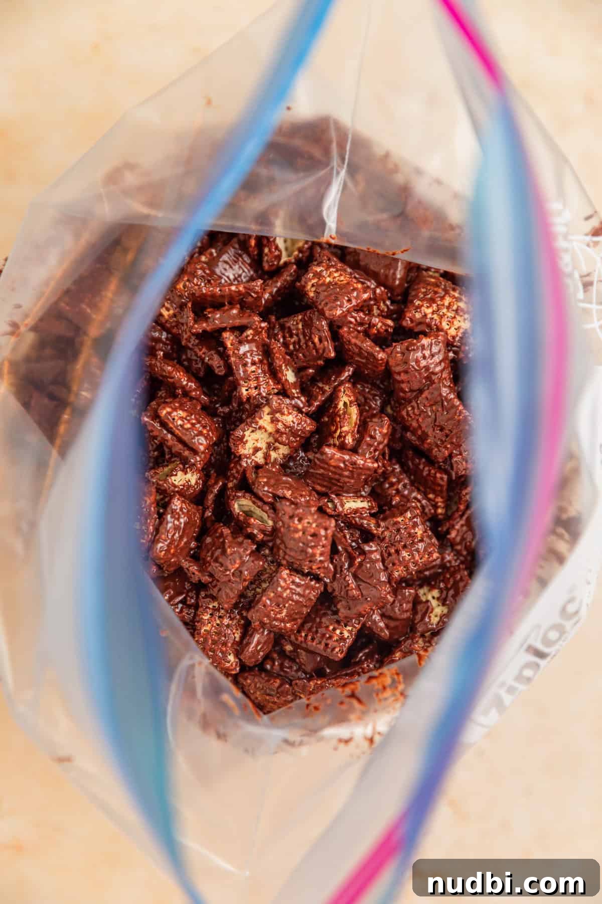 Christmas Puppy Chow Recipe: Festive Snack Mix for Holiday Parties 7 Plastic bag with chocolate coated cereal.