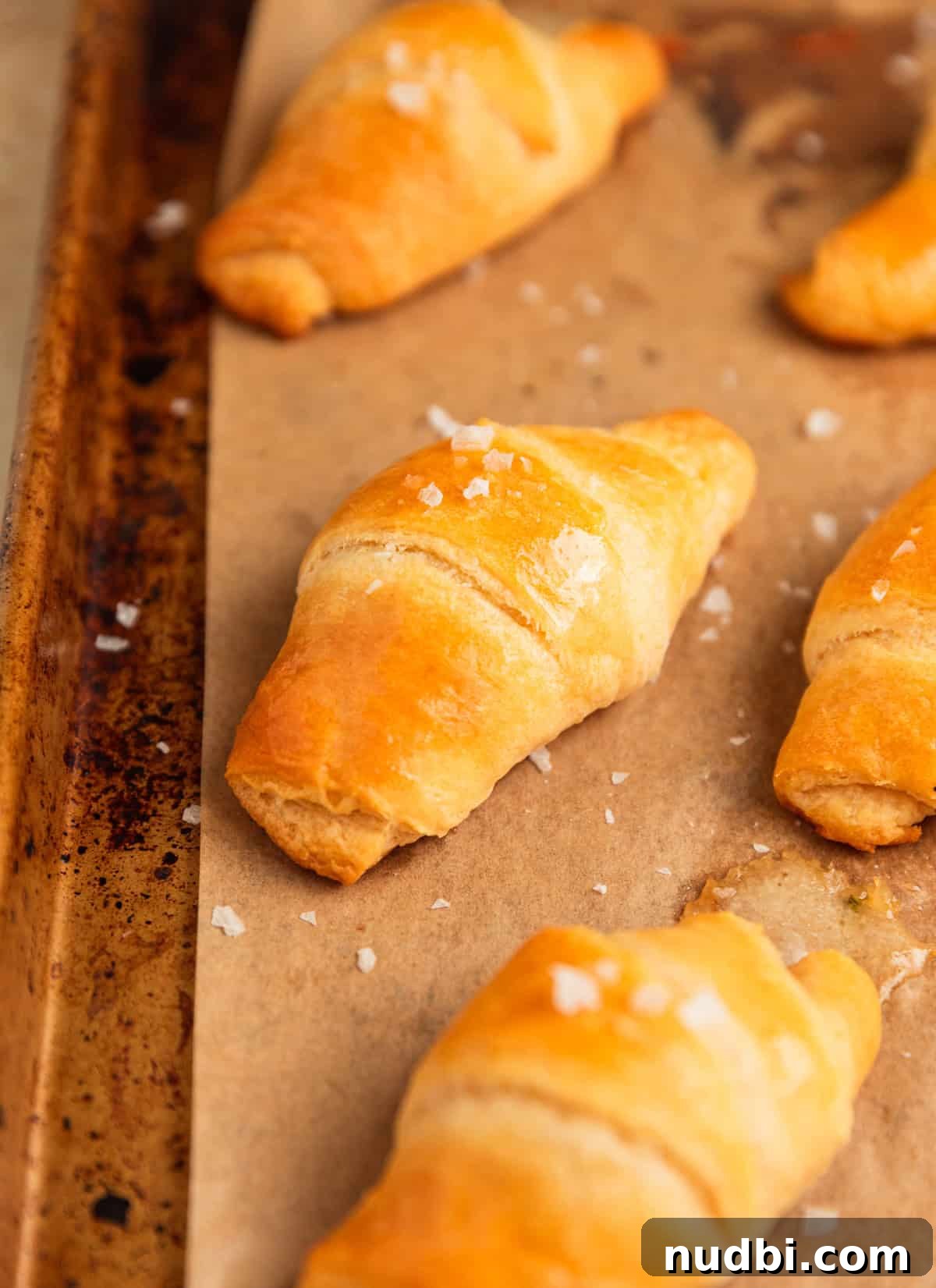 Baked Brie Crescent Rolls with Honey & Cranberry Jam 8 Butter topped crescent rolls on pan.