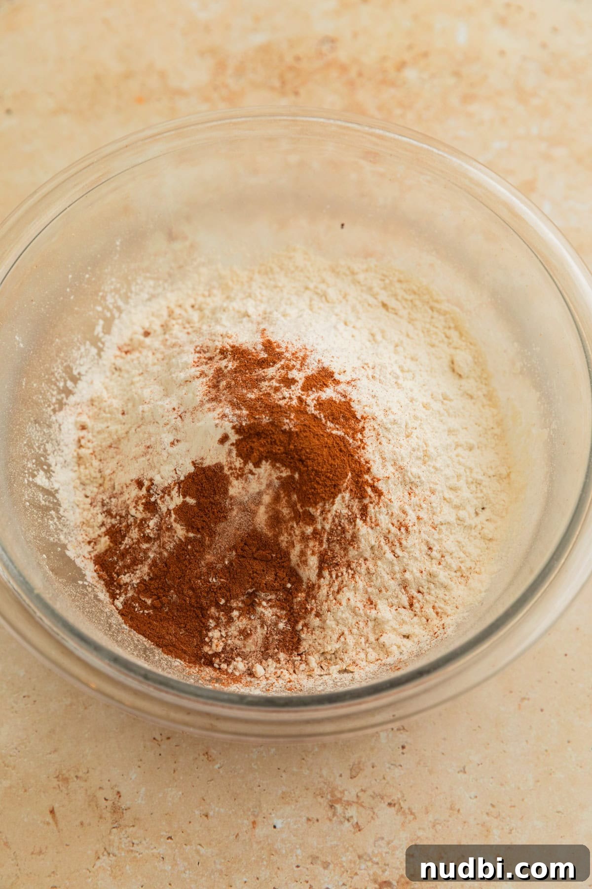 Cinnamon Roll Breakfast Cookies: Soft, Swirled Morning Treats 6 Cinnamon, flour and quick oats in bowl before stirring.