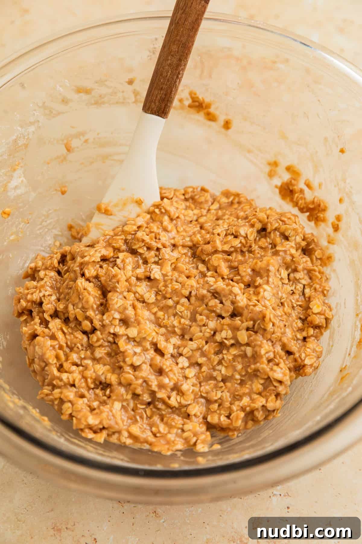 Cinnamon Roll Breakfast Cookies: Soft, Swirled Morning Treats 8 Cinnamon oatmeal cookie dough in bowl with spatula.