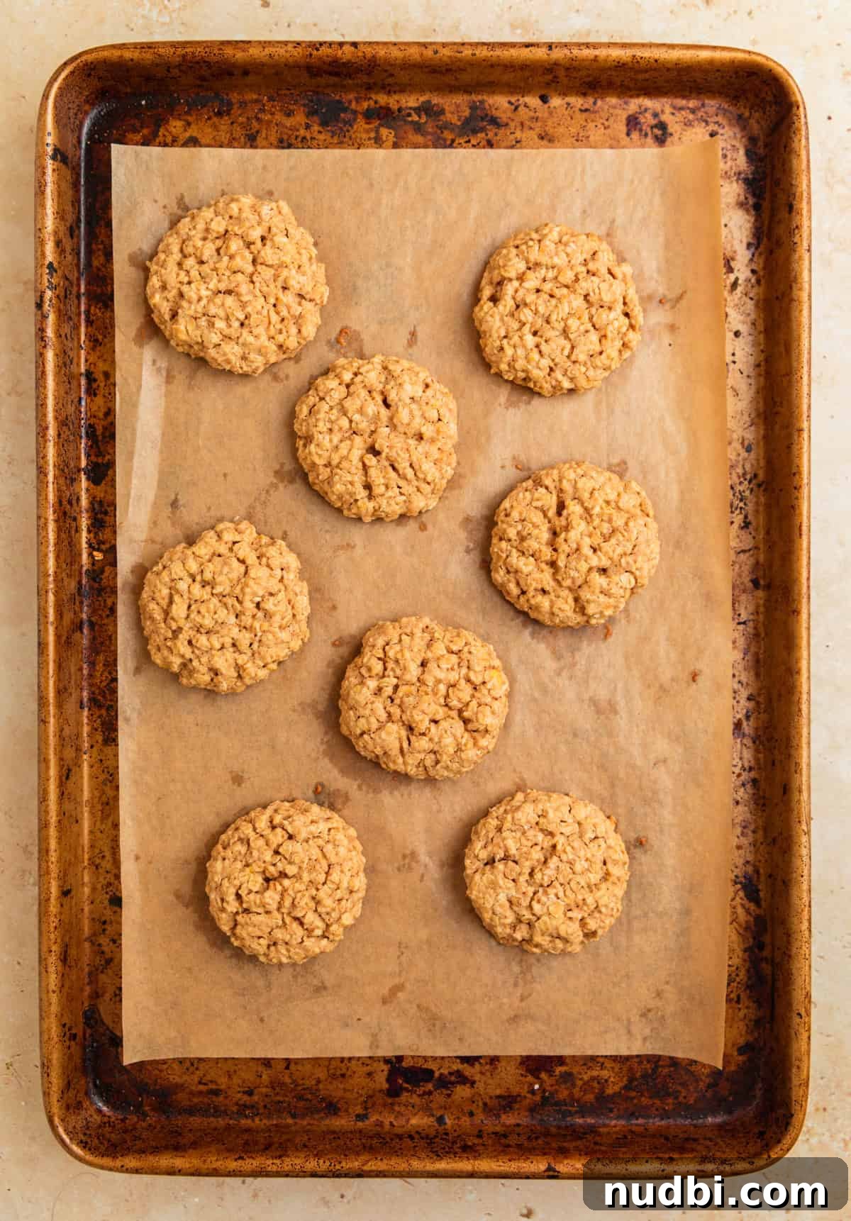 Cinnamon Roll Breakfast Cookies: Soft, Swirled Morning Treats 10 Baked cinnamon roll oatmeal cookies on cookie sheet.