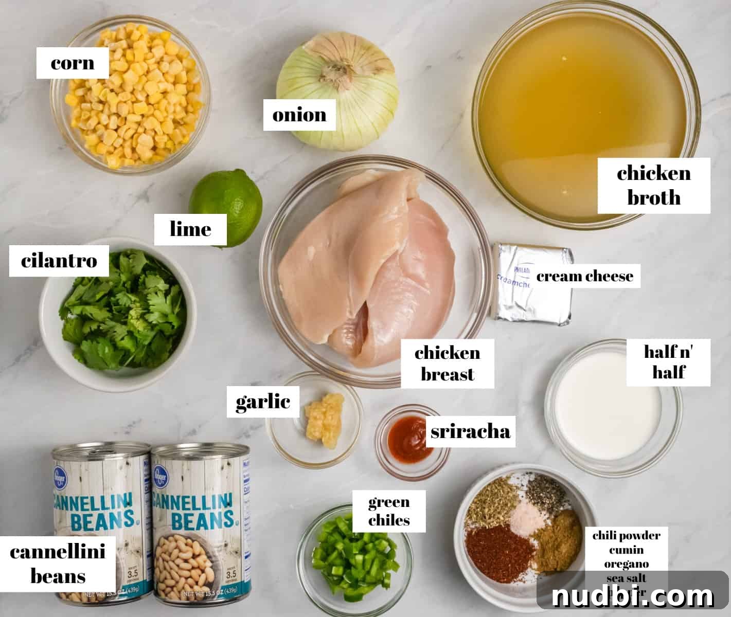 Creamy Slow Cooker White Chicken Chili Recipe 3 Chicken, cilantro, cream cheese, broth, beans etc. on counter labeled.
