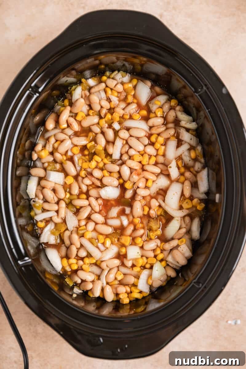Creamy Slow Cooker White Chicken Chili Recipe 6 Mixed white chicken chili ingredients in crockpot before cooking.