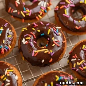 Light and Fluffy Greek Yogurt Donuts Recipe 11 Chocolate glazed baked donuts on wire cooling rack.