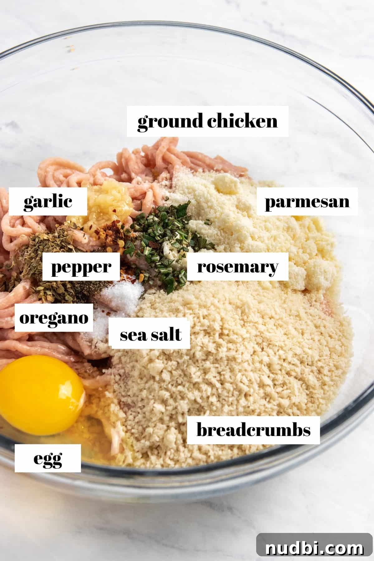 Parmesan & Rosemary Baked Chicken Meatballs Recipe 3 Ground chicken, egg, parmesan, bread crumbs and other ingredients labeled in mixing bowl.
