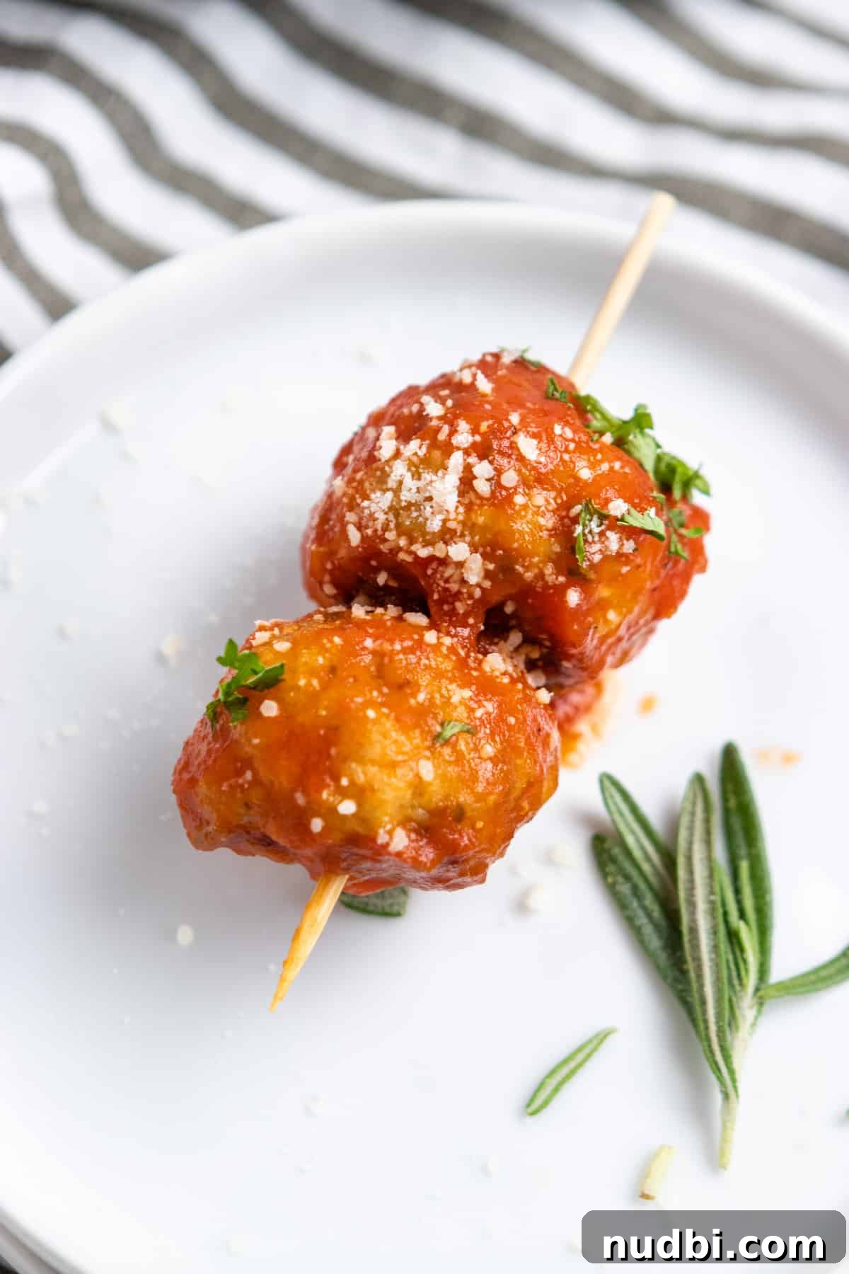 Parmesan & Rosemary Baked Chicken Meatballs Recipe 5 Meatballs with marinara on skewer.