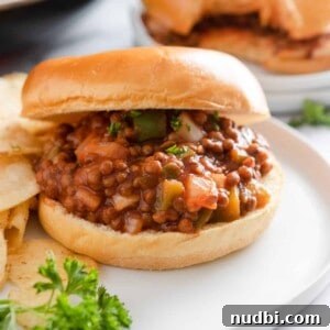 15-Minute Vegan Sloppy Joes Recipe for Quick Weeknight Meals 7 Vegan sloppy Joes on bun with chips.