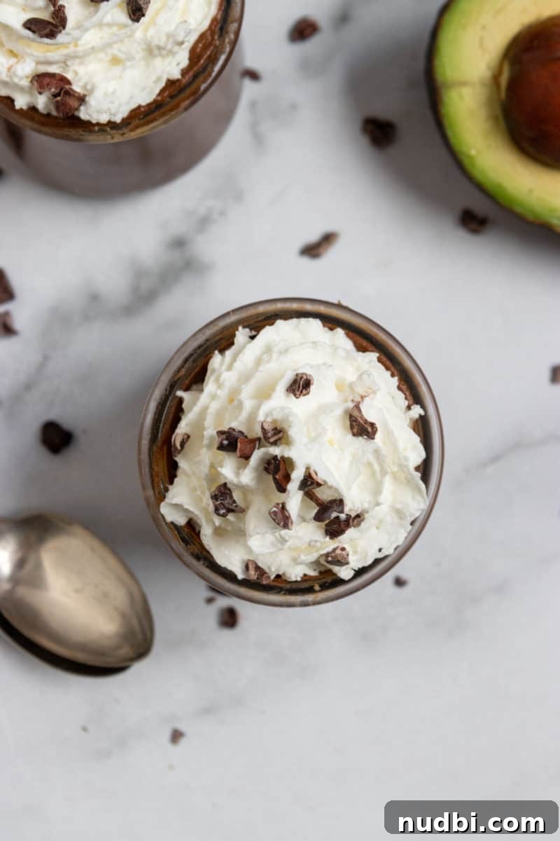 Bailey’s Dark Chocolate Avocado Mousse Recipe 5 Overhead shot of avocado mousse with whipped cream.