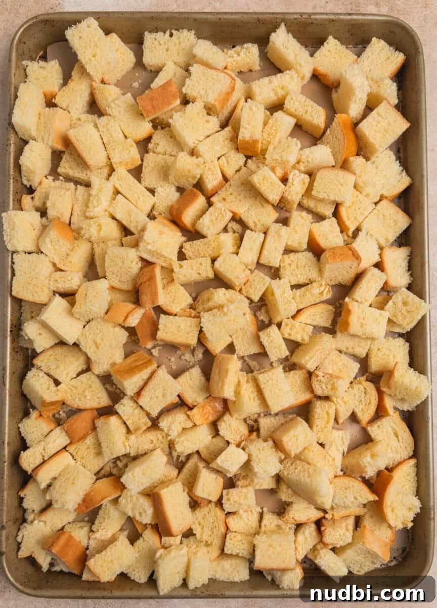 Cinnamon French Toast Muffins: Quick Breakfast Muffin Recipe 4 Brioche bread cubed on baking pan.