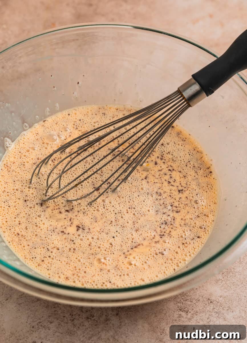 Cinnamon French Toast Muffins: Quick Breakfast Muffin Recipe 6 French toast egg mixture in glass bowl with whisk.