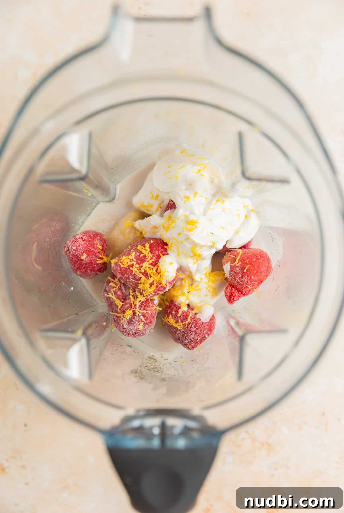 Refreshing Strawberry Lemonade Smoothie Recipe for Summer Sips 3 Frozen strawberries, yogurt, lemon zest, frozen banana and other ingredients in blender.