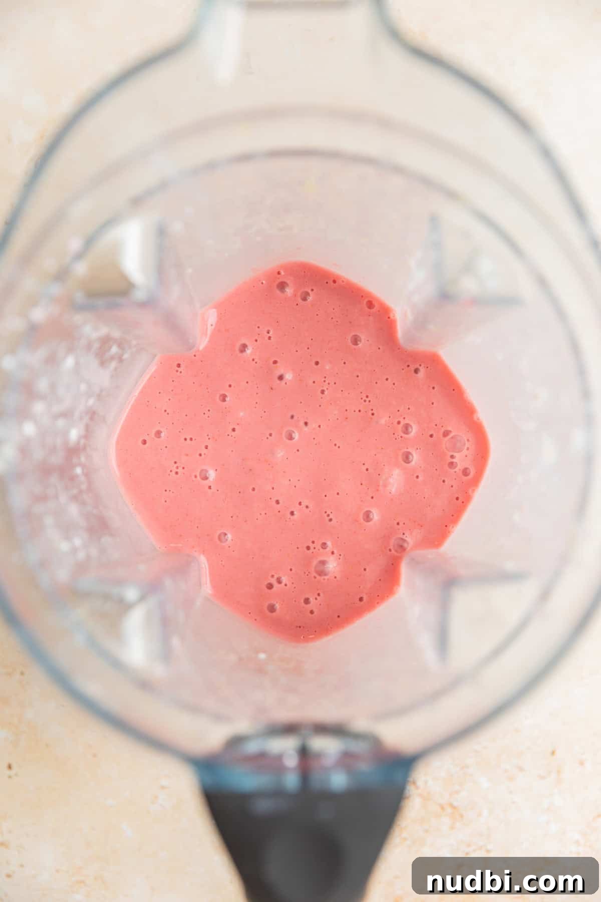 Refreshing Strawberry Lemonade Smoothie Recipe for Summer Sips 4 Strawberry lemon smoothie mixture blended in blender.