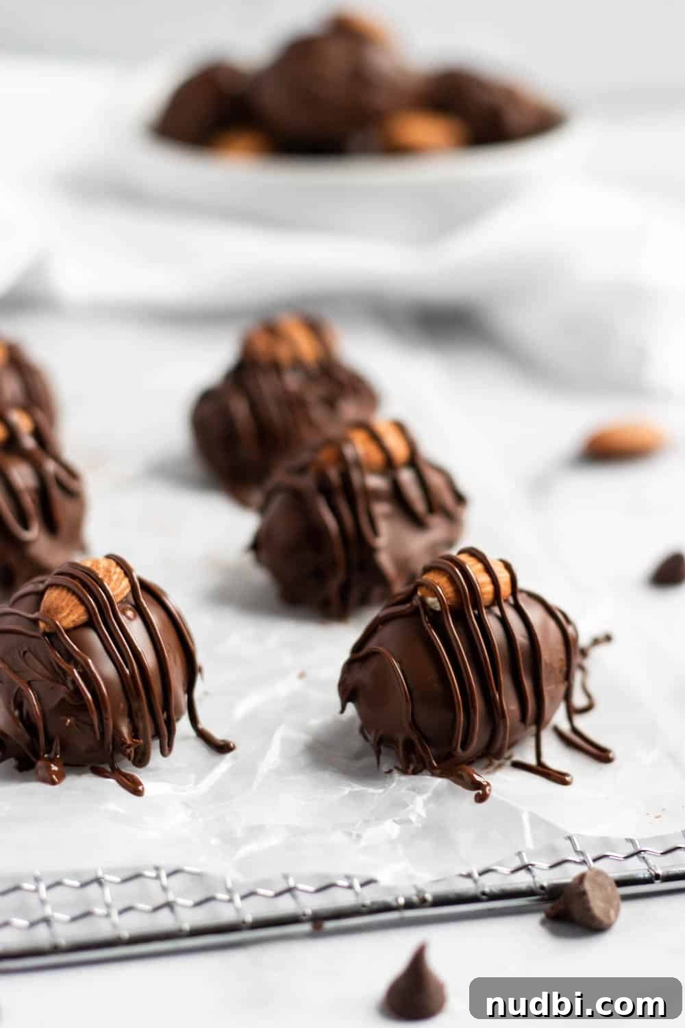 Homemade Almond Joy Bars Recipe with Coconut, Chocolate & Almonds 2 Almond joy candies on wax paper.