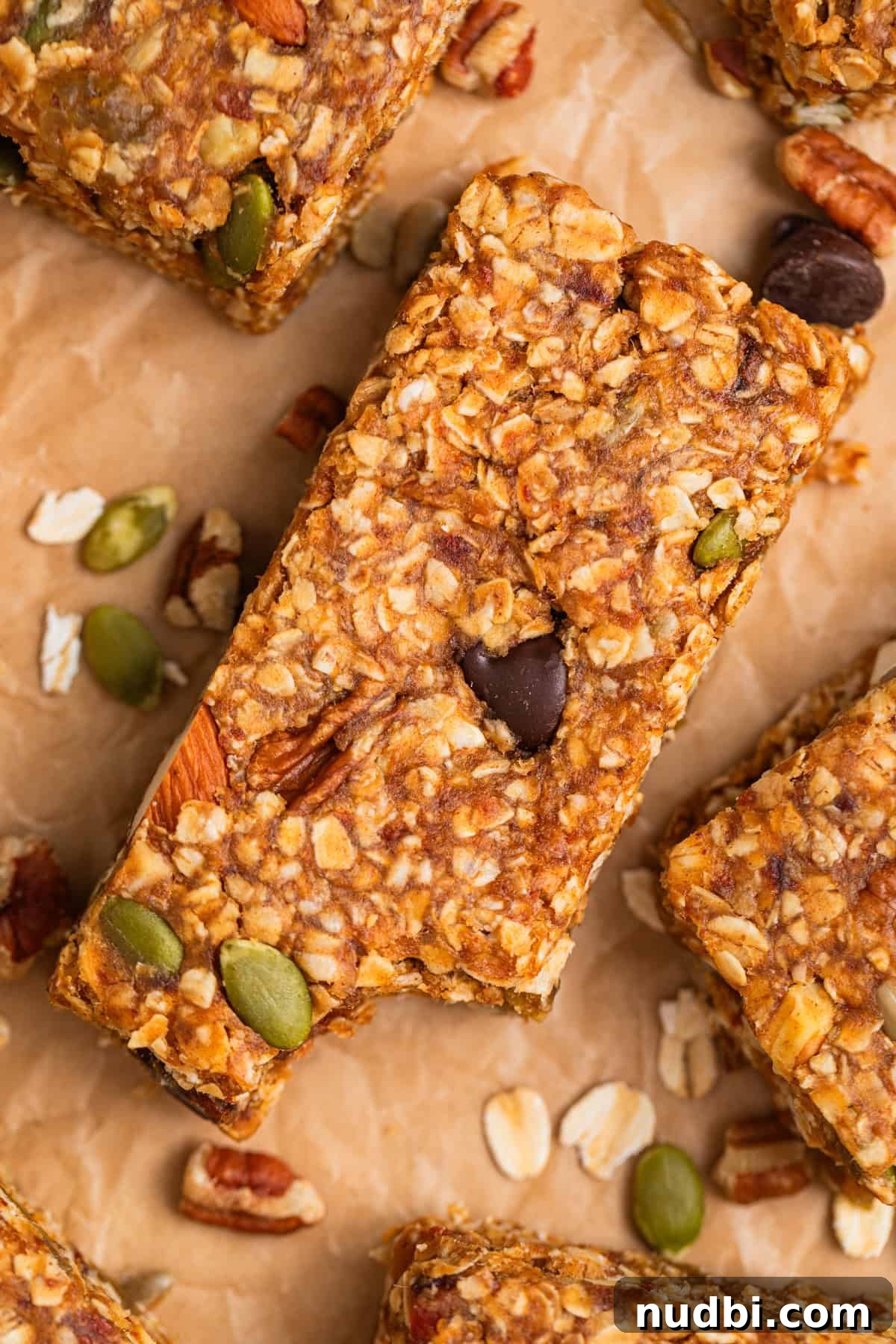 Homemade Trail Mix Bars Recipe – Portable Snack Bars for Hiking 2 No bake trail mix bar on parchment with bite taken out of it.