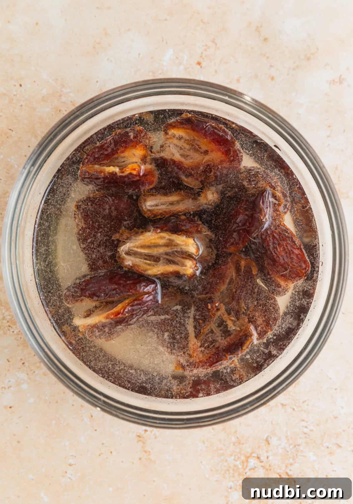 Homemade Trail Mix Bars Recipe – Portable Snack Bars for Hiking 4 Dates soaking in water in small glass bowl.