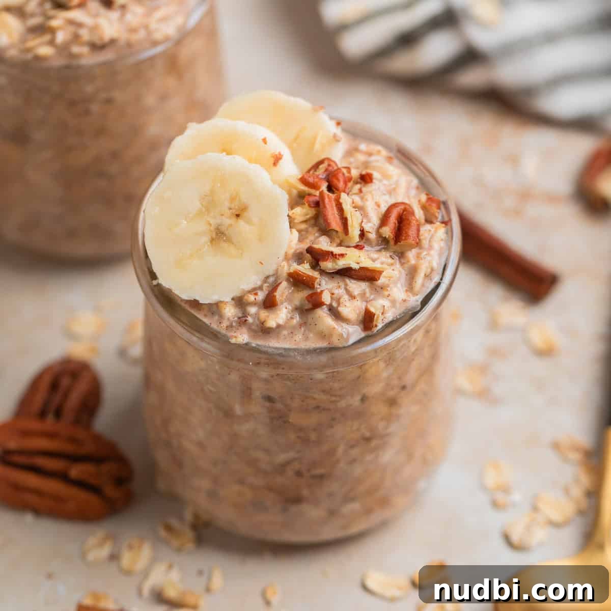 Glass jar with overnight oatmeal topped with bananas and nuts.