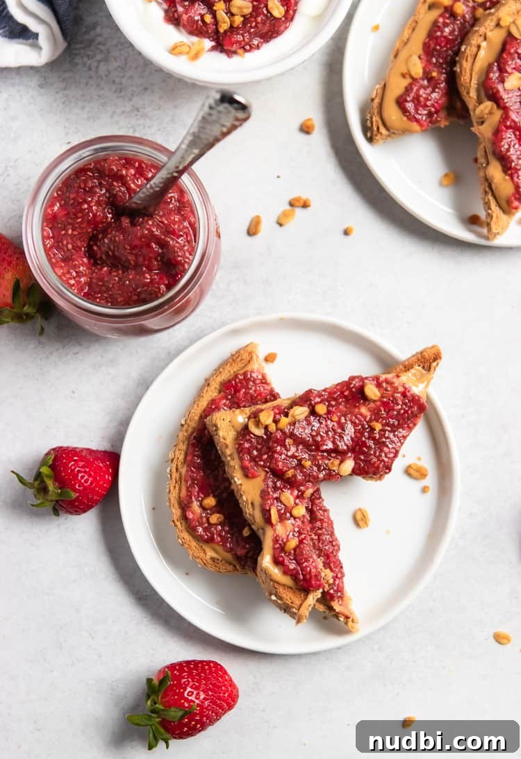 Overhead view of jam on peanut butter toast with bite taken out.