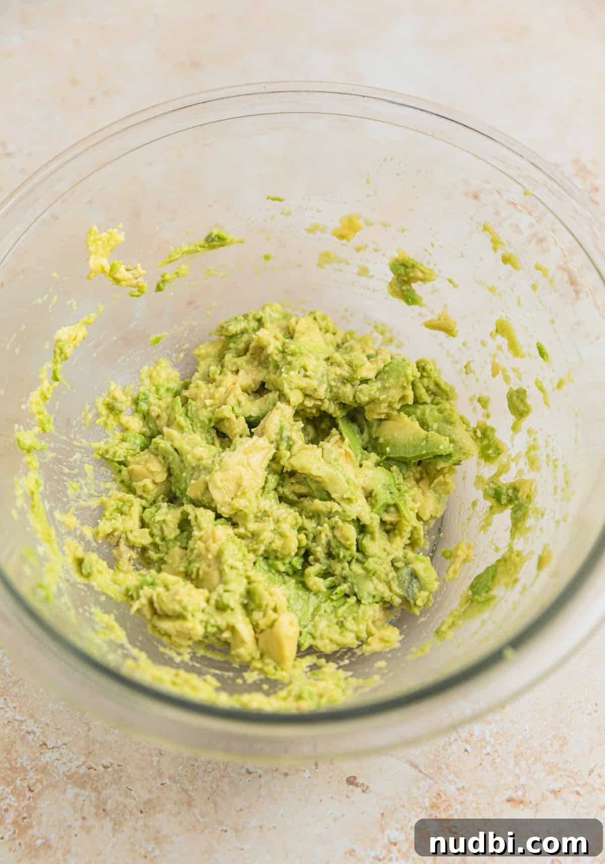 Creamy Avocado Ranch Tuna Salad with Fresh Herbs 4 Glass mixing bowl with mashed avocado.