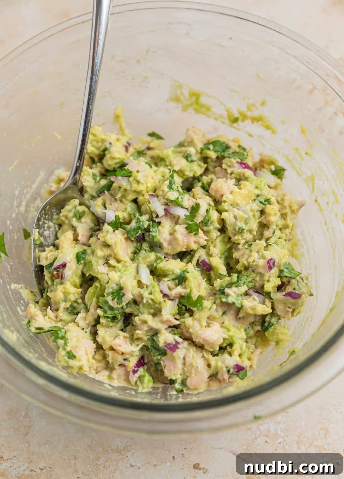 Creamy Avocado Ranch Tuna Salad with Fresh Herbs 6 Avocado tuna salad mixed in bowl with spoon.