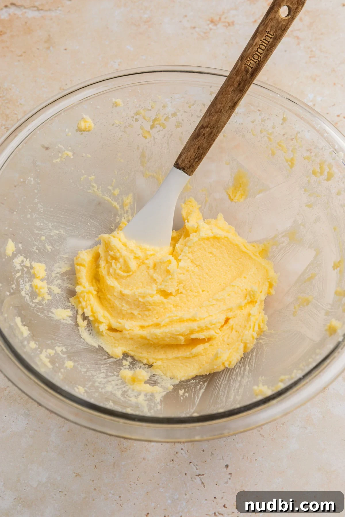 Safe-to-Eat Sugar Cookie Dough Recipe for Snacking 4 Creamed butter and sugar in glass mixing bowl with spatula.