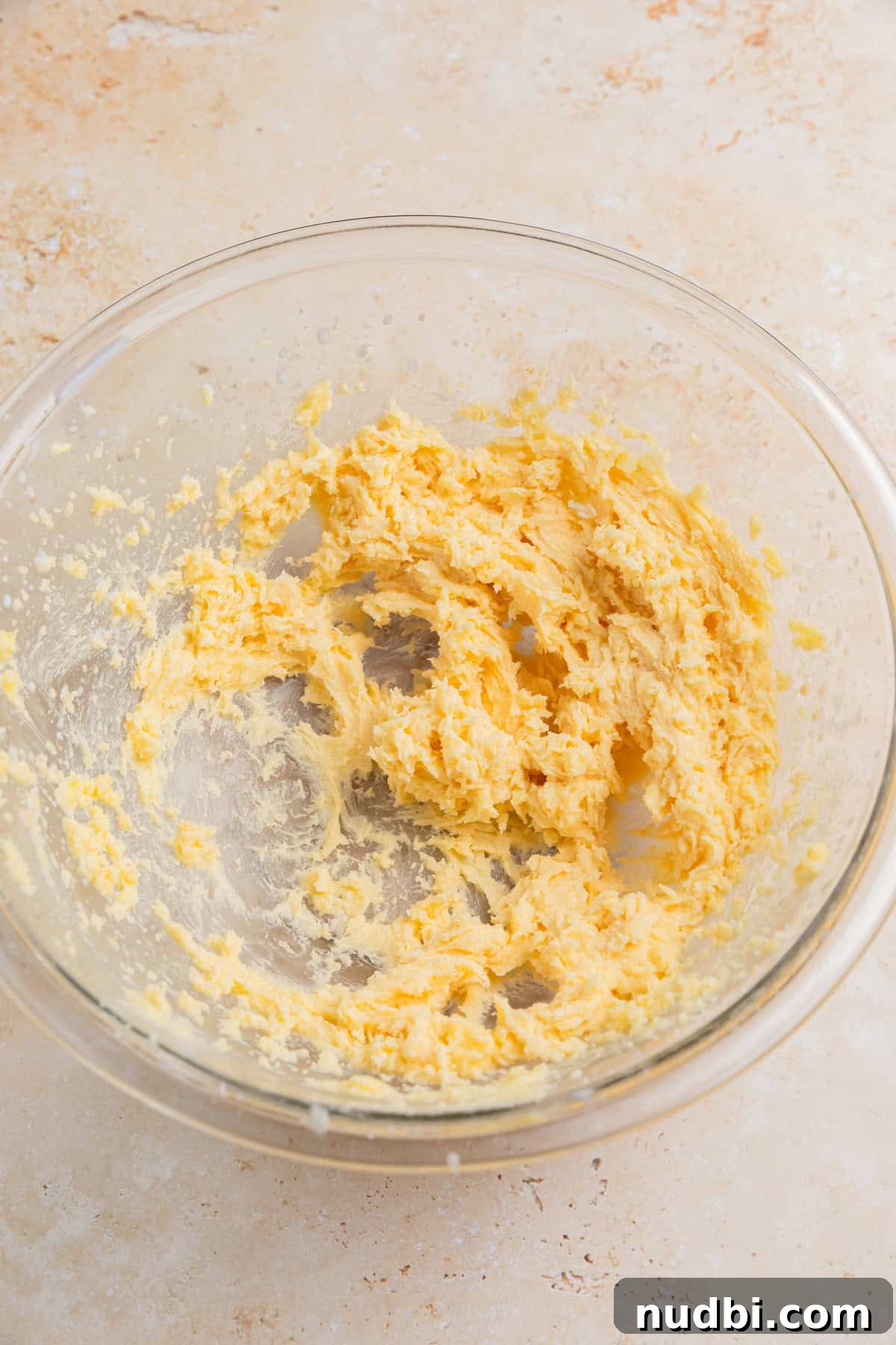 Safe-to-Eat Sugar Cookie Dough Recipe for Snacking 5 Milk and vanilla added to creamed butter and sugar in bowl.