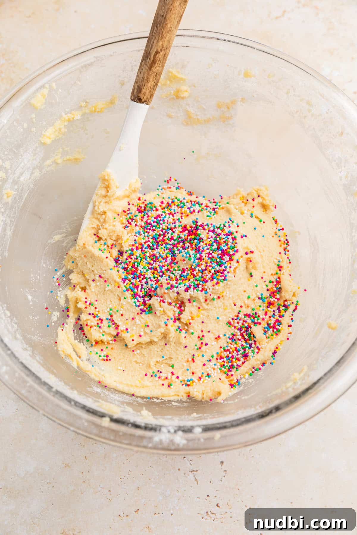 Safe-to-Eat Sugar Cookie Dough Recipe for Snacking 6 Sprinkles added to edible sugar cookie dough in bowl.