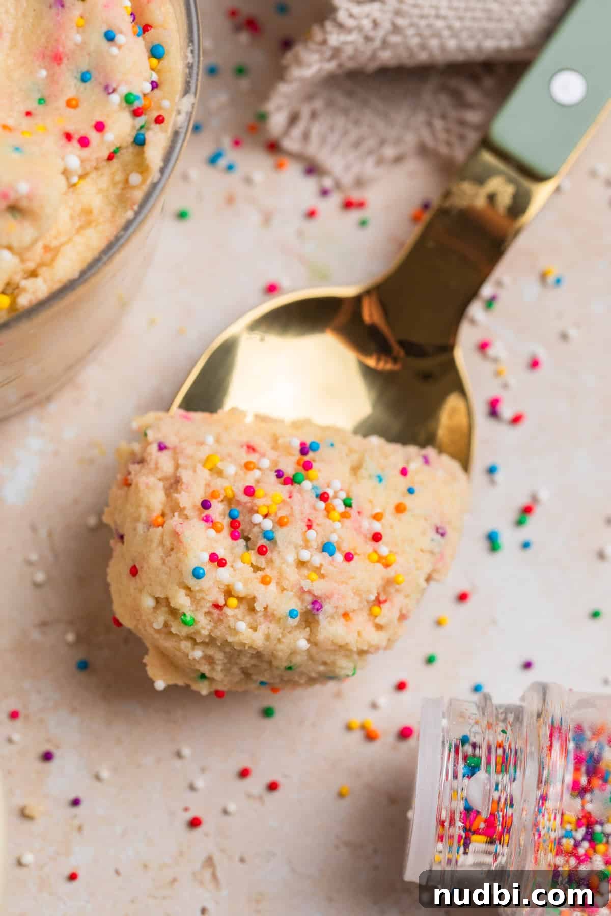 Safe-to-Eat Sugar Cookie Dough Recipe for Snacking 8 Spoonful of sugar cookie dough with nonpareils.