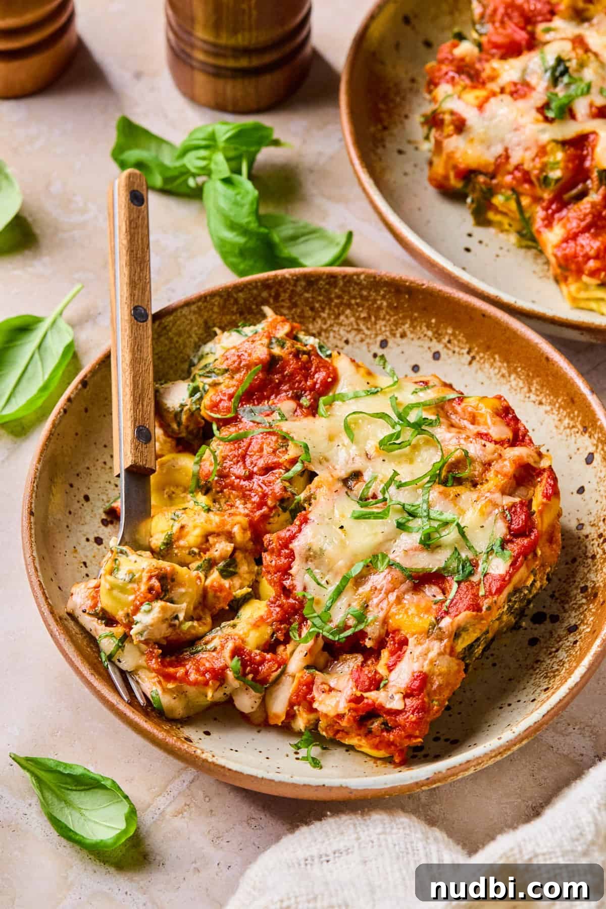 Creamy Spinach and Ricotta Tortellini Bake 11 Cheesy tortellini pasta bake on plate with fork.