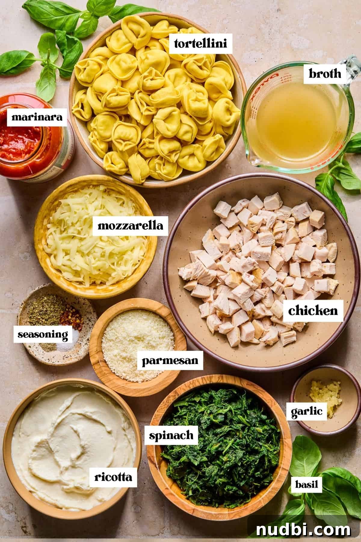 Creamy Spinach and Ricotta Tortellini Bake 4 Ricotta, spinach, marinara, pasta and other ingredients labeled on surface.