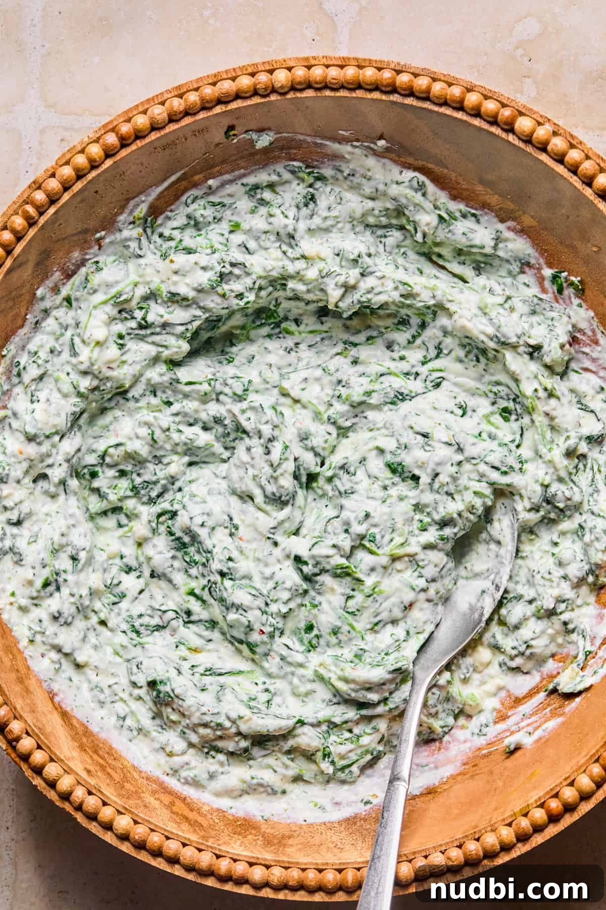 Creamy Spinach and Ricotta Tortellini Bake 6 Spinach and ricotta mixture in bowl with spoon.